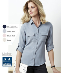 Inspect a sample of the Madison Blouse #S626LL. The Madison is a versatile workplace uniform blouse available in Midnight Blue, Silver Mist, Blush Pink, Ivory. Wear it sleeves down and tucked in for a streamlined look or roll up the sleeves and wear loosely out for a contemporary cool style. Available Long, Short and Sleeveless.  Fuss free fabric with a litte STRETCH so you will be comfortable all day long. Sizes 6-26. For all the details on Staff Uniforms please call Renee Kinnear or Shelley Morris on FreeCall 1800 654 990